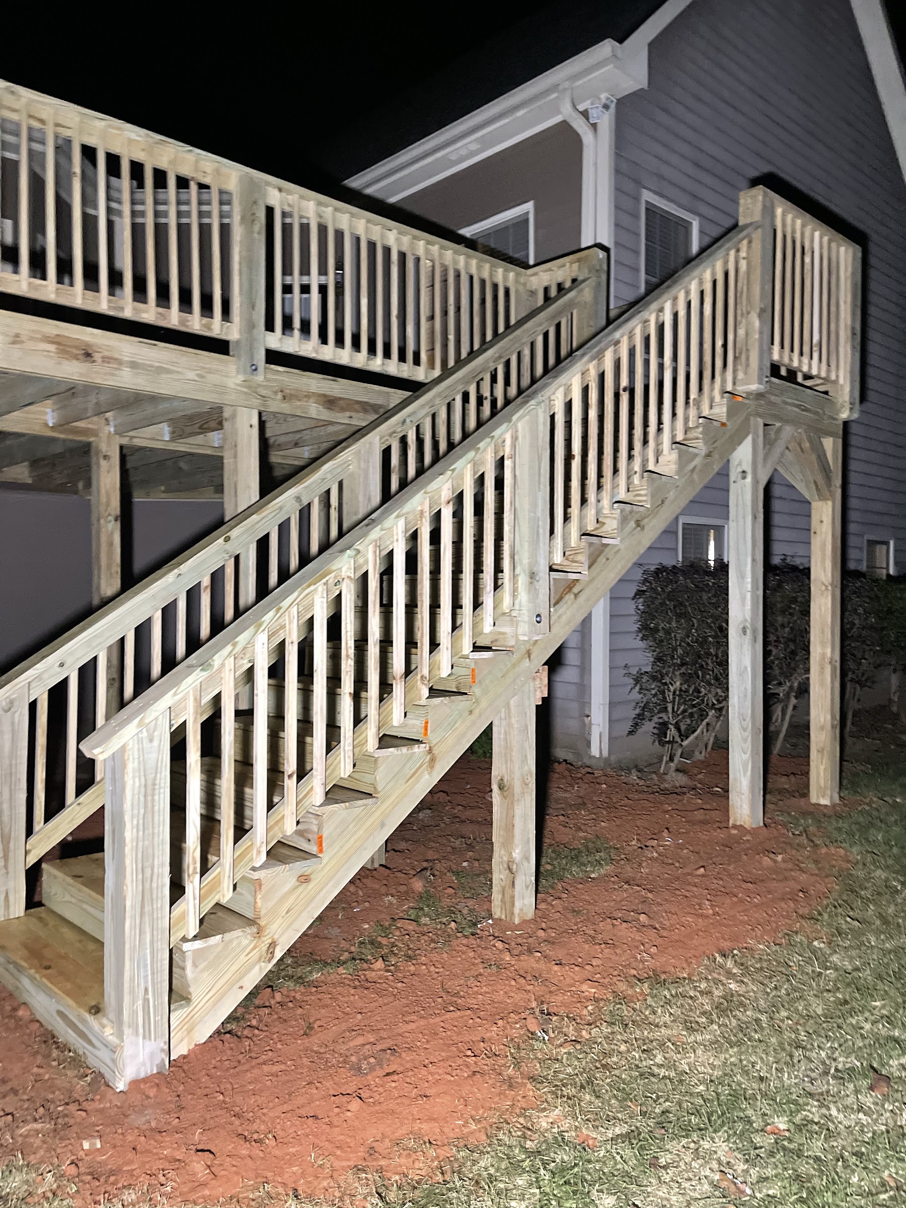New pressure-treated wood deck with stair run, installed in NE Georgia