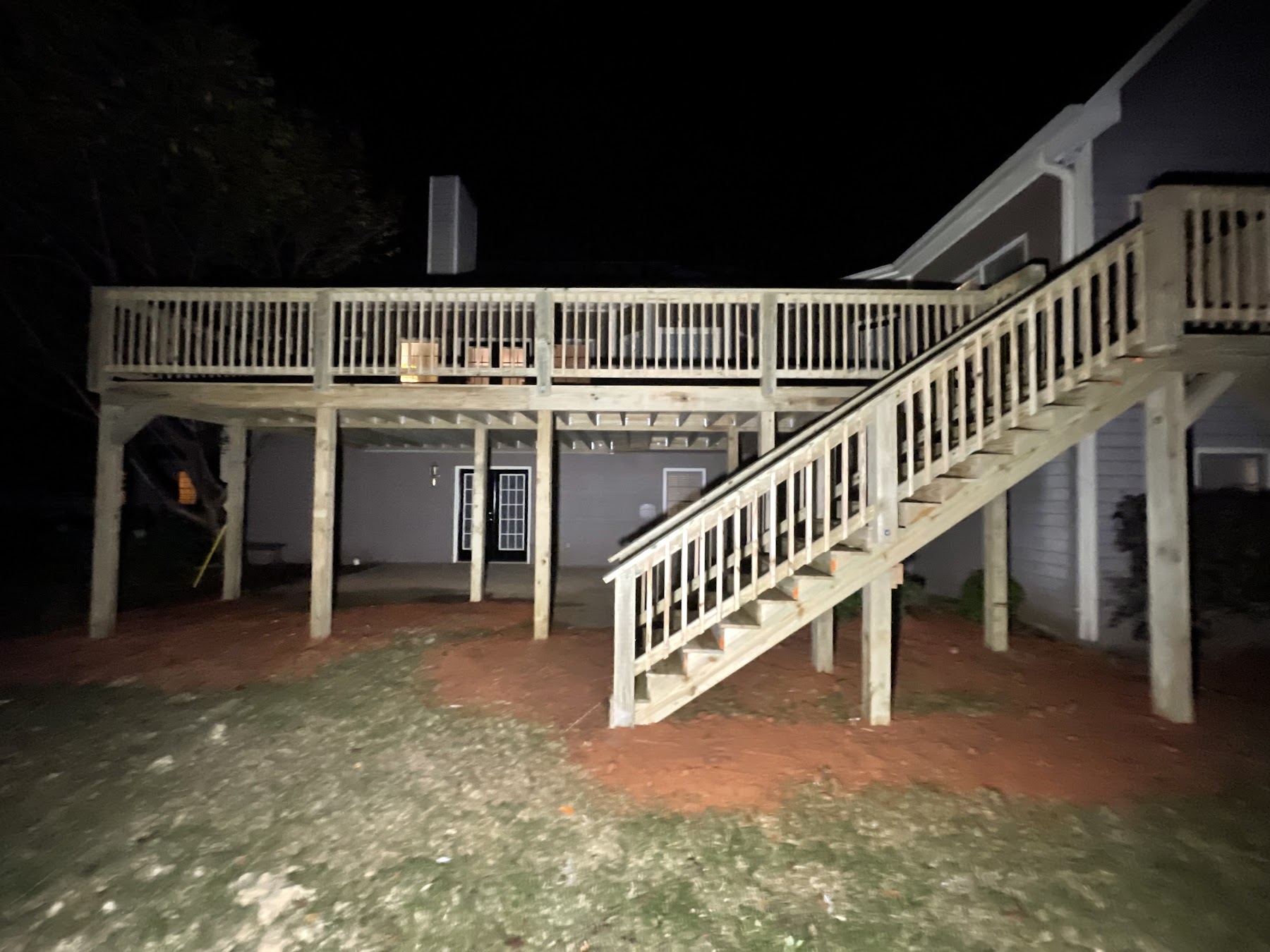 Fully-built two-level deck with stairs at night