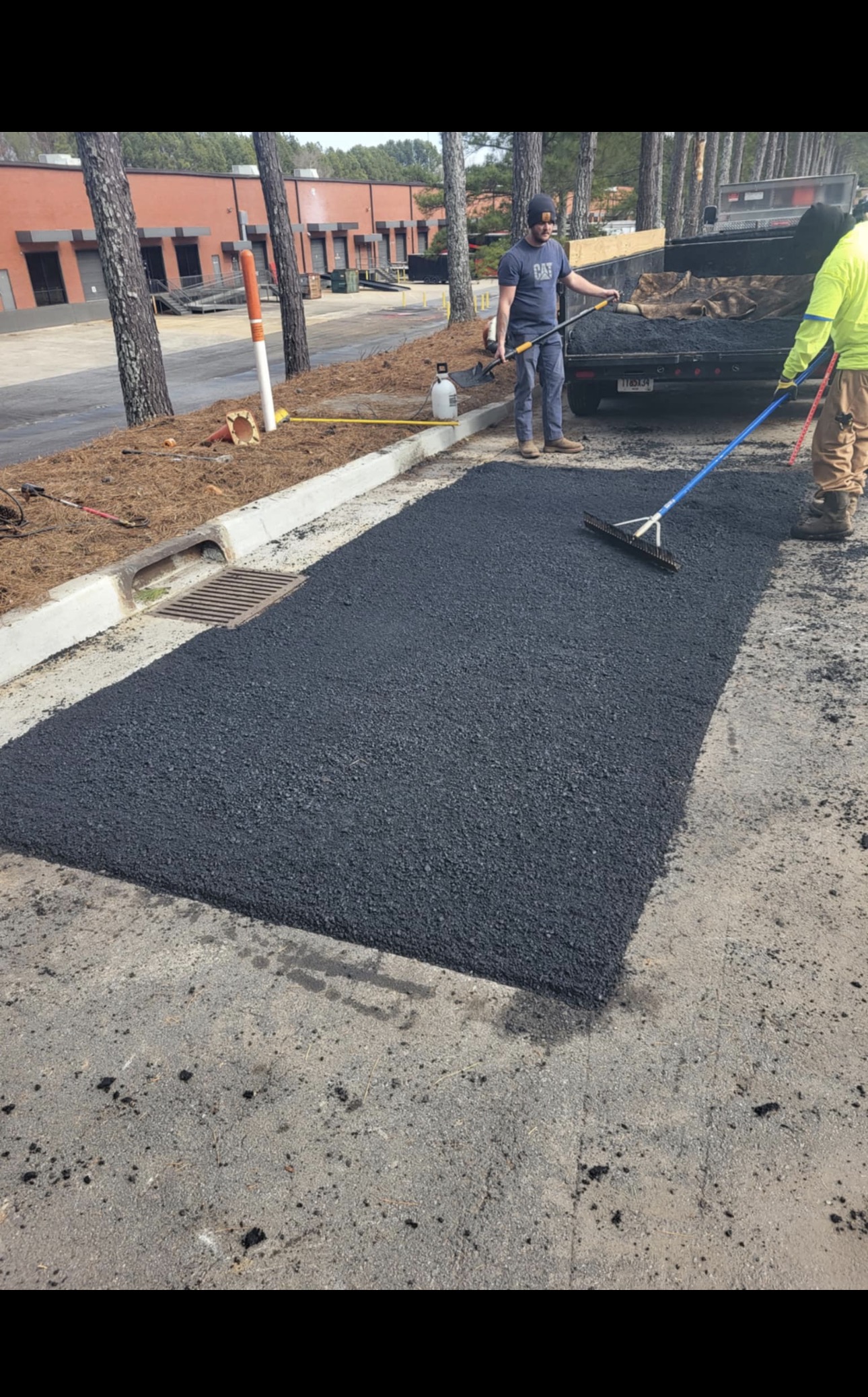 CCL crew spreading fresh asphalt across a driveway section