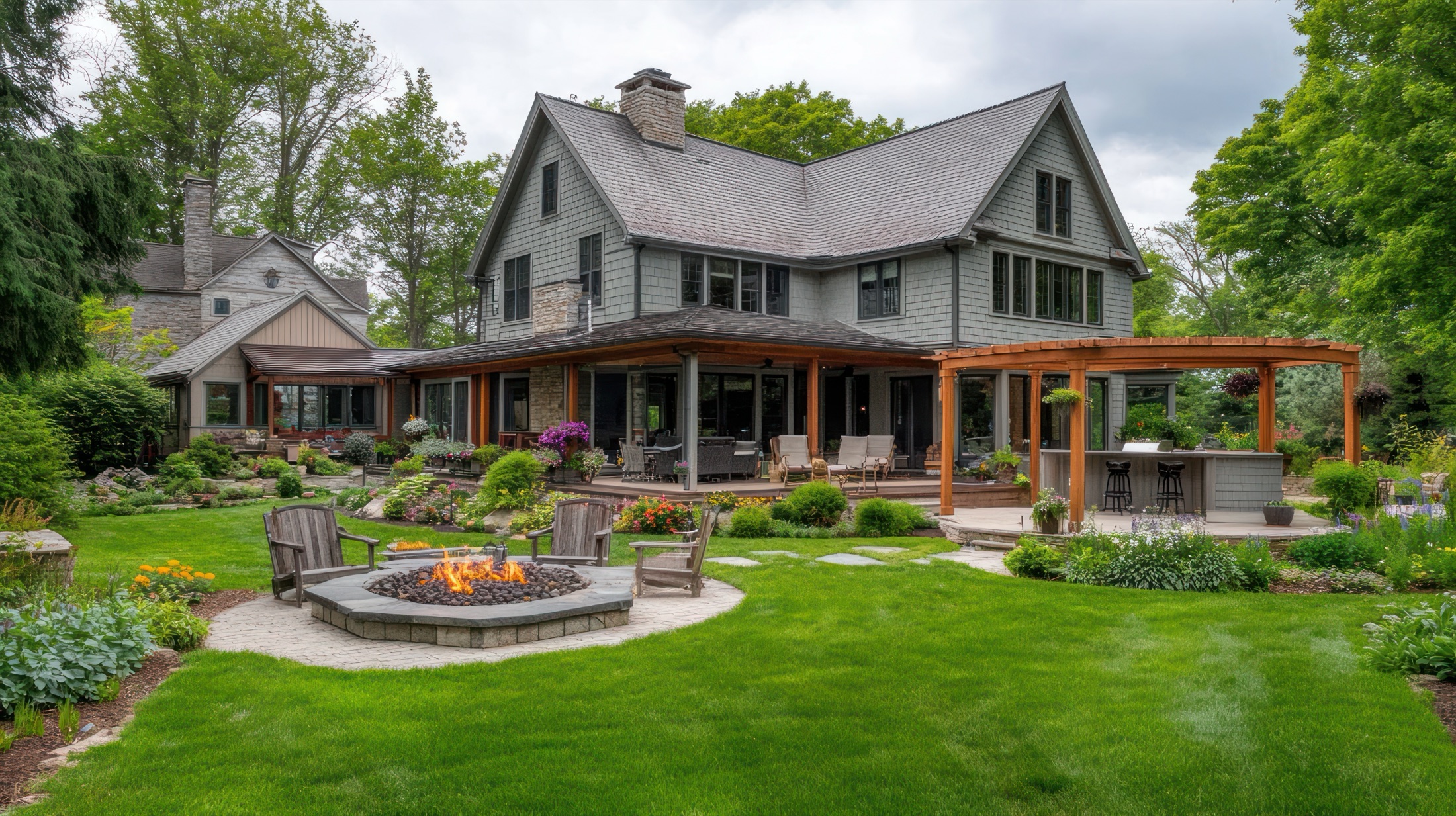 Craftsman home with lush landscaped backyard, fire pit, Adirondack chairs, and pergola-covered patio